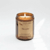 Amber jar candle with lit wick